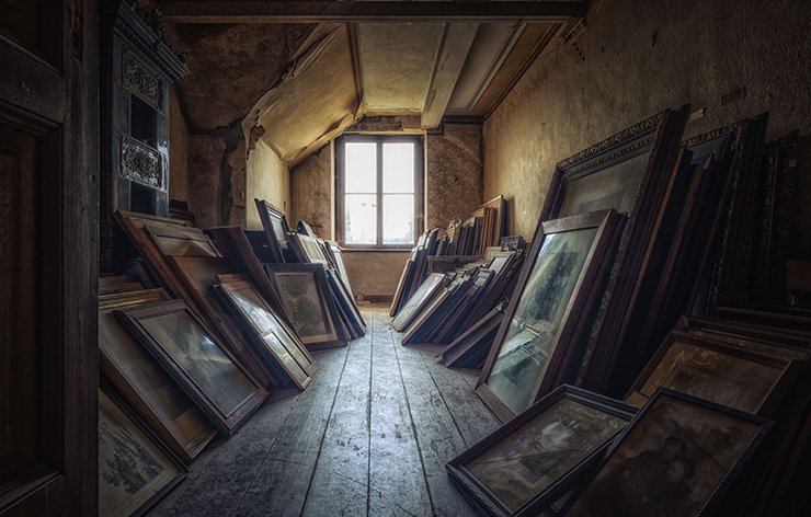 Attic contains a bunch of old photo-frames.