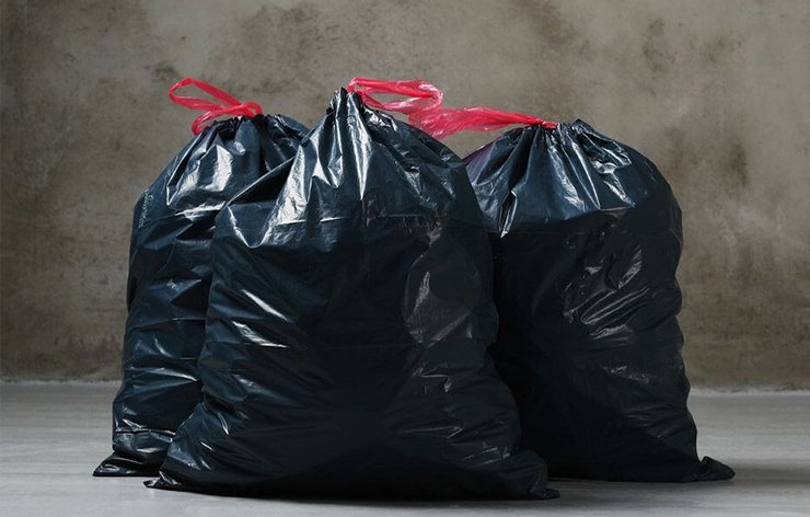 A group of trash black plastic bags.